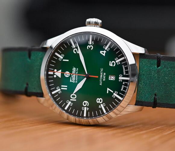 The orange second hand is striking to the green dial.